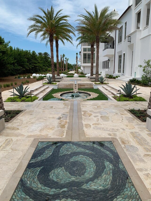 view of community featuring a patio area and a hot tub