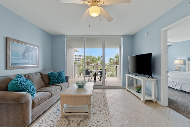 living room with light tile patterned floors, floor to ceiling windows, light carpet, and a ceiling fan