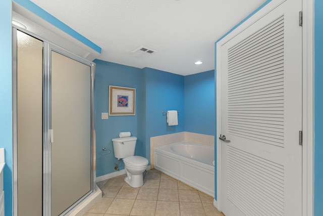 bathroom with baseboards, tile patterned flooring, a shower stall, a garden tub, and toilet