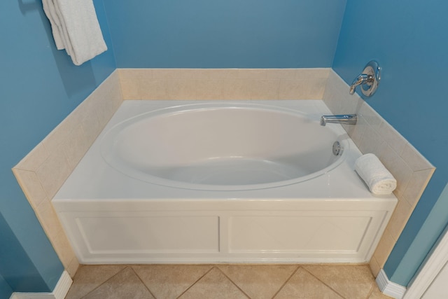 bathroom with a bath and tile patterned flooring