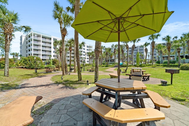 view of community featuring a yard and a patio area