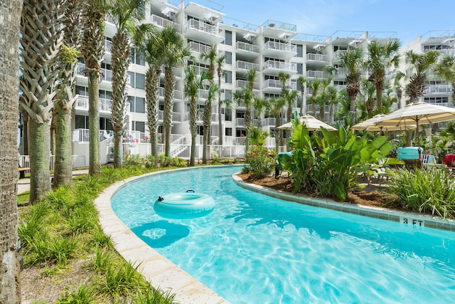 view of swimming pool featuring fence