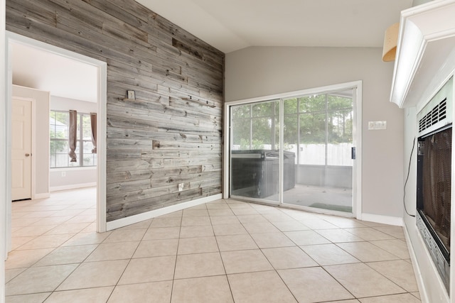 1634 N Campbell Dr, Fort Walton Beach, FL 32547 - spare room with wood walls, light tile patterned floors, baseboards, lofted ceiling, and an accent wall