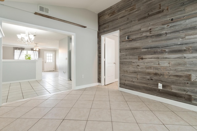 1634 N Campbell Dr, Fort Walton Beach, FL 32547 - spare room with light tile patterned flooring, a notable chandelier, visible vents, wood walls, and vaulted ceiling