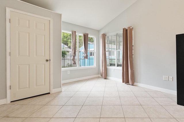 1634 N Campbell Dr, Fort Walton Beach, FL 32547 - unfurnished room featuring baseboards, light tile patterned floors, and vaulted ceiling