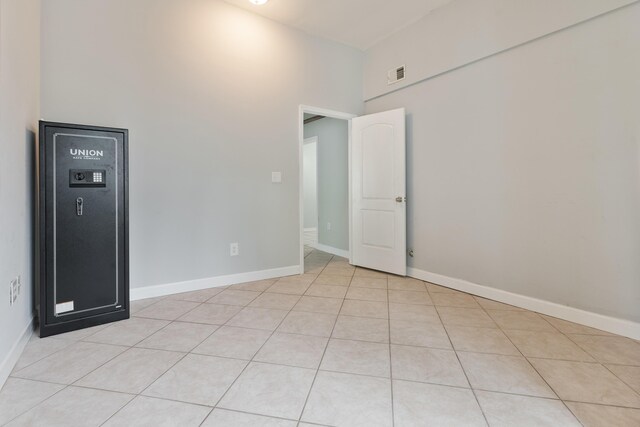 1634 N Campbell Dr, Fort Walton Beach, FL 32547 - unfurnished room featuring baseboards, visible vents, light tile patterned floors, and a towering ceiling