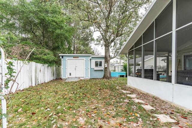 1634 N Campbell Dr, Fort Walton Beach, FL 32547 - view of yard with fence, an outdoor structure, a sunroom, and a storage shed