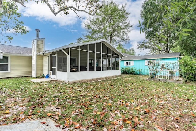 1634 N Campbell Dr, Fort Walton Beach, FL 32547 - back of house with a sunroom, a yard, and a chimney