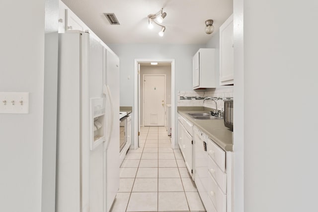 1634 N Campbell Dr, Fort Walton Beach, FL 32547 - kitchen with white cabinets, white refrigerator with ice dispenser, a sink, light tile patterned floors, and visible vents