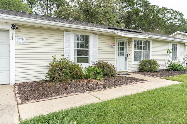 1634 N Campbell Dr, Fort Walton Beach, FL 32547 - view of front facade with a garage, a shingled roof, and driveway