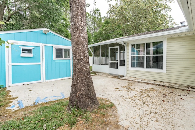 1634 N Campbell Dr, Fort Walton Beach, FL 32547 - exterior space with an outbuilding, a sunroom, and a storage unit