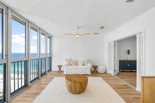 5801 Thomas Dr Unit 1414, Panama City Beach, FL 32408 - living area featuring a wealth of natural light, visible vents, a textured ceiling, and a water view
