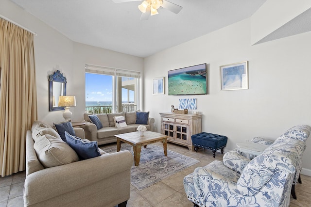 living area featuring light tile patterned flooring and a ceiling fan