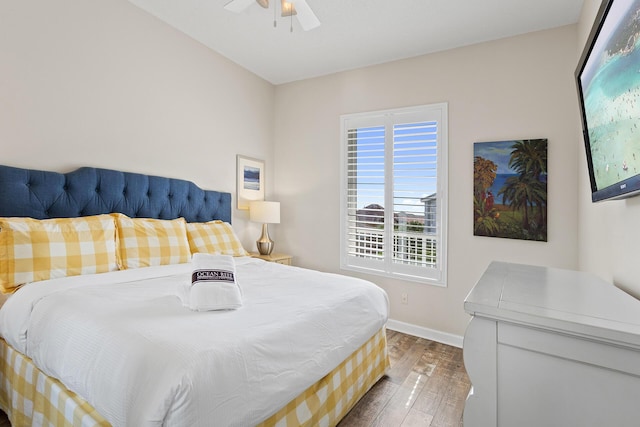 bedroom featuring a ceiling fan, wood finished floors, and baseboards