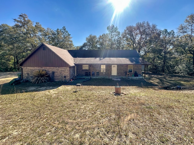 exterior space featuring brick siding and a lawn