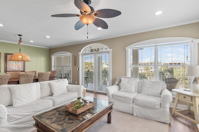 living area with recessed lighting, wood finished floors, and ornamental molding