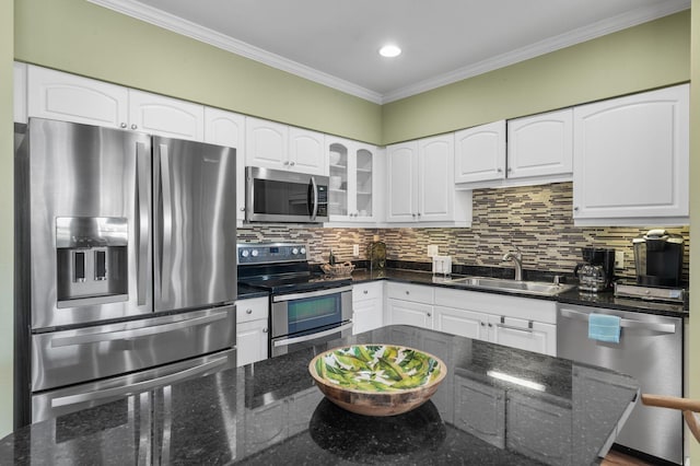 kitchen featuring tasteful backsplash, ornamental molding, appliances with stainless steel finishes, and a sink