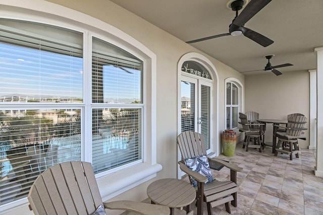 view of patio / terrace featuring outdoor dining space, a balcony, and ceiling fan