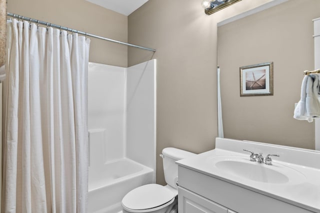 bathroom with toilet, vanity, and shower / tub combo