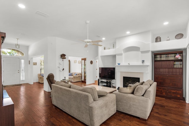 living area featuring visible vents, dark wood-type flooring, recessed lighting, a fireplace, and a ceiling fan