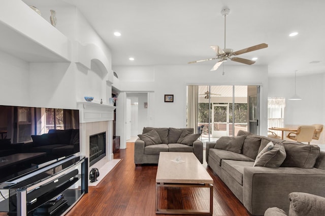 living area with recessed lighting, a ceiling fan, dark wood-style floors, and a fireplace