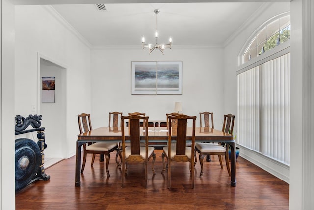 dining space with ornamental molding, visible vents, dark wood-style flooring, and a chandelier