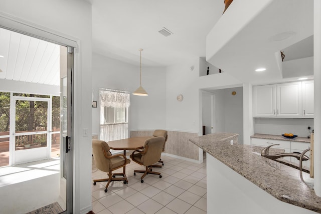 dining space featuring visible vents, wooden walls, wainscoting, recessed lighting, and light tile patterned flooring