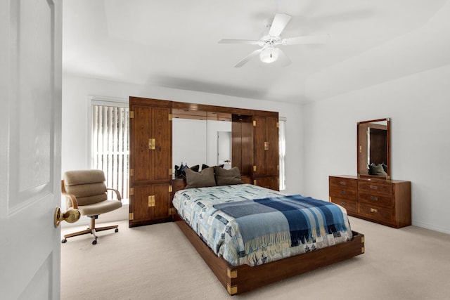 bedroom featuring light carpet and a ceiling fan