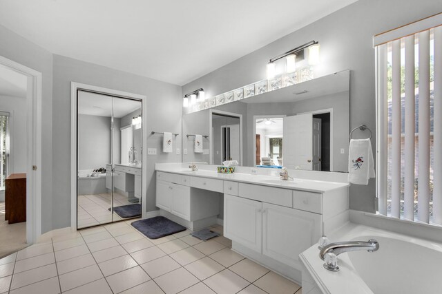 full bathroom featuring a sink, a bath, double vanity, and tile patterned flooring