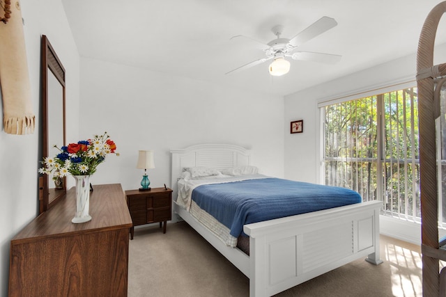 bedroom featuring ceiling fan and light carpet