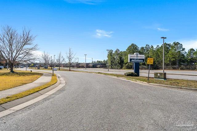 1607 Woodlawn Way, Gulf Breeze, FL 32563 - view of asphalt street featuring sidewalks and curbs