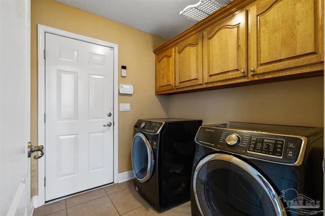 1607 Woodlawn Way, Gulf Breeze, FL 32563 - laundry area with washing machine and clothes dryer, cabinet space, and light tile patterned flooring