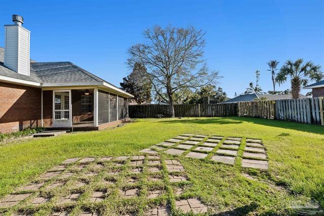 1607 Woodlawn Way, Gulf Breeze, FL 32563 - fenced backyard with a sunroom