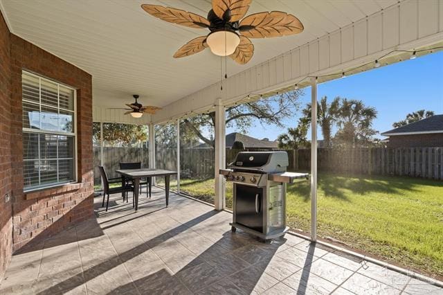 1607 Woodlawn Way, Gulf Breeze, FL 32563 - fenced backyard with grilling area, a ceiling fan, outdoor dining area, and a patio area