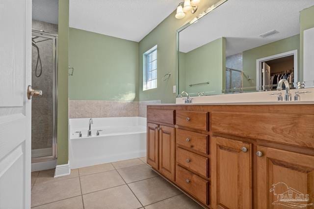 1607 Woodlawn Way, Gulf Breeze, FL 32563 - bathroom featuring tile patterned floors, a shower stall, double vanity, and a garden tub