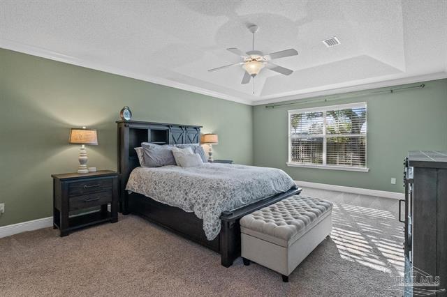 1607 Woodlawn Way, Gulf Breeze, FL 32563 - bedroom featuring carpet, a raised ceiling, crown molding, and a ceiling fan