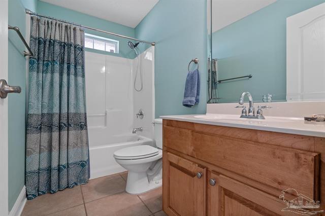 1607 Woodlawn Way, Gulf Breeze, FL 32563 - full bath with vanity, shower / tub combo, and tile patterned floors