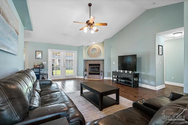 1607 Woodlawn Way, Gulf Breeze, FL 32563 - living room featuring lofted ceiling, ceiling fan, and wood finished floors
