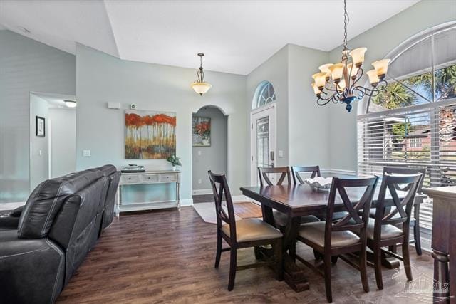 1607 Woodlawn Way, Gulf Breeze, FL 32563 - dining space featuring arched walkways, healthy amount of natural light, wood finished floors, a chandelier, and high vaulted ceiling