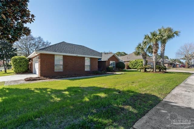 view of side of home with a garage, concrete driveway, and a yard