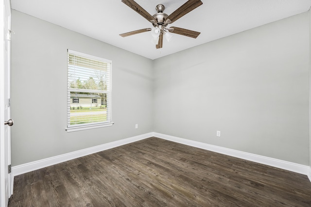 unfurnished room with dark wood finished floors, a ceiling fan, and baseboards