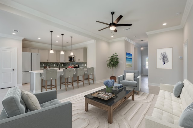 living room with recessed lighting, visible vents, and ornamental molding