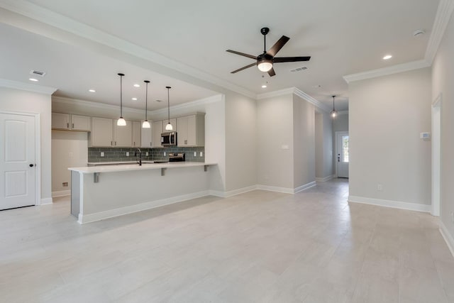 kitchen featuring stainless steel appliances, a peninsula, light countertops, decorative backsplash, and ceiling fan