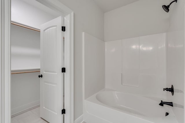 bathroom featuring baseboards and shower / washtub combination