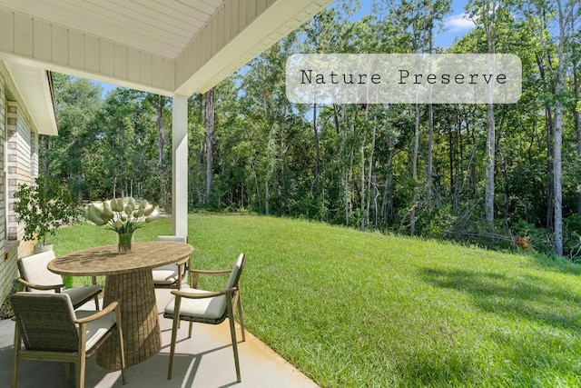 view of yard with a patio and outdoor dining space