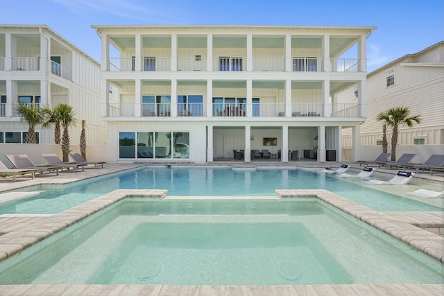 view of pool with a pool with connected hot tub and a patio