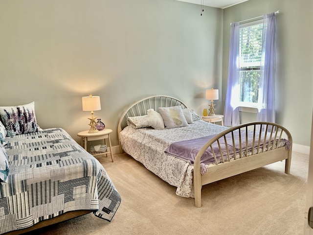 carpeted bedroom featuring baseboards