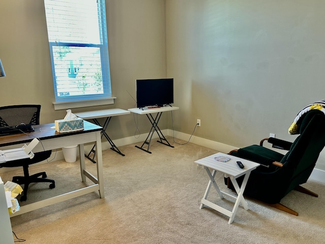 carpeted home office featuring baseboards