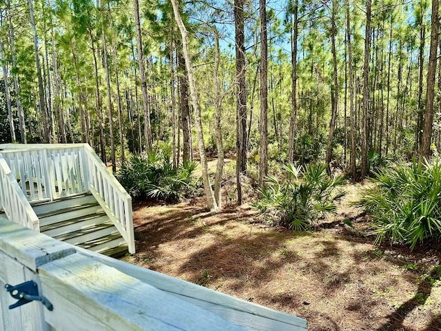 view of yard with a view of trees