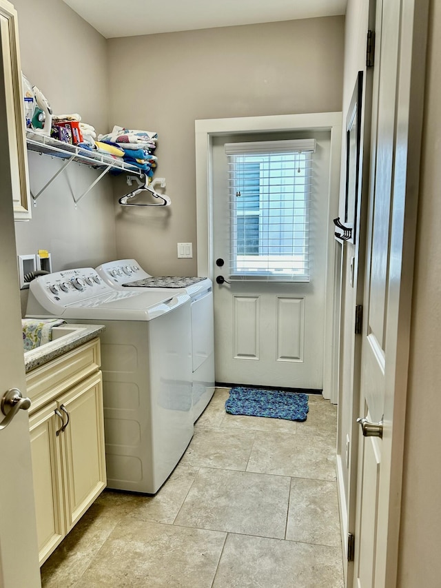 laundry room featuring cabinet space and separate washer and dryer